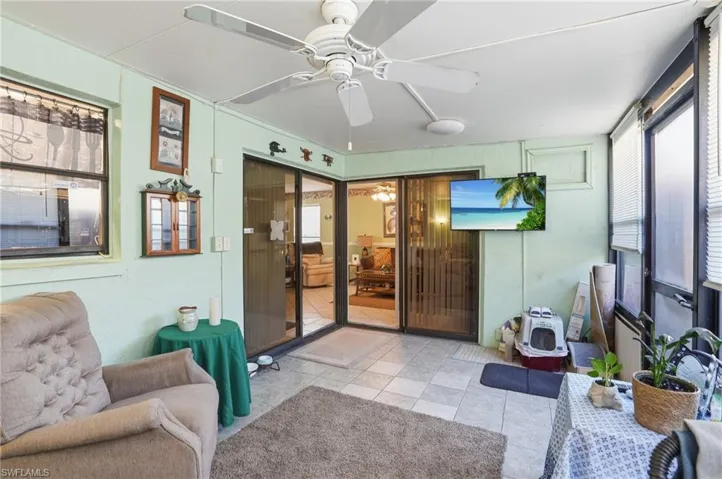 Sunroom featuring ceiling fan