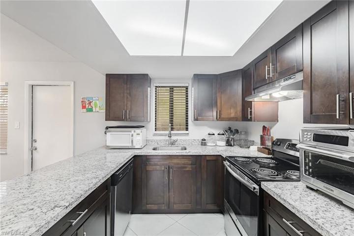 Kitchen features granite countertops and stainless steel appliances.