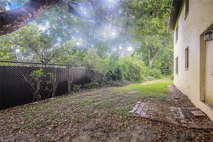 Backyard offers plenty of space for pavers and a grill.