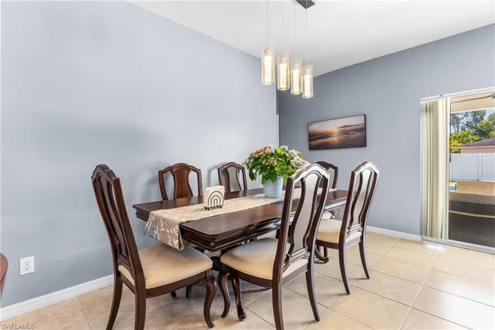Dining area featuring neutral tile flooring and light blue walls