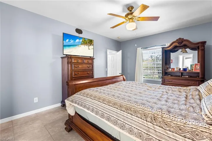 Spacious room with cool-toned wall paint and tile flooring