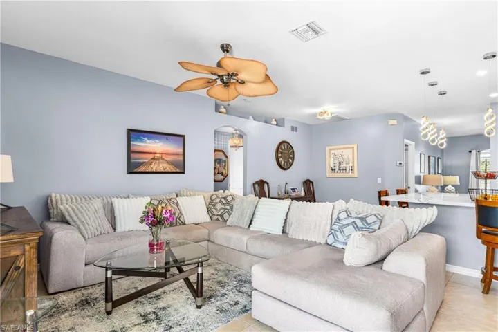Living area featuring light blue walls and recessed lighting