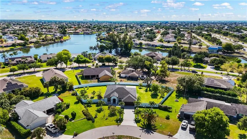 Aerial perspective showcasing a residential area with waterways and lush landscaping