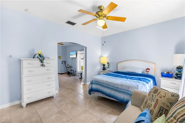 Light blue interior walls with a ceiling fan, recessed lighting, and tile flooring