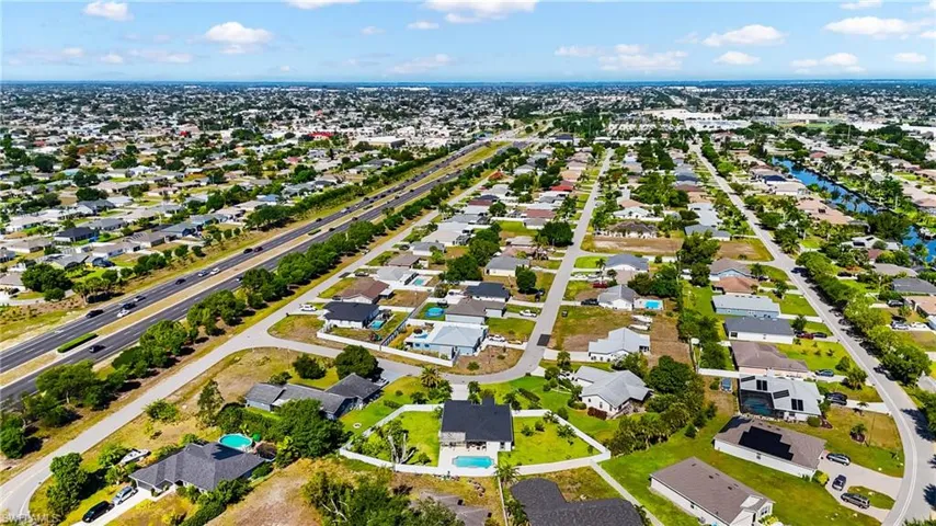 Expansive residential area featuring numerous single-story homes, many with private swimming pools