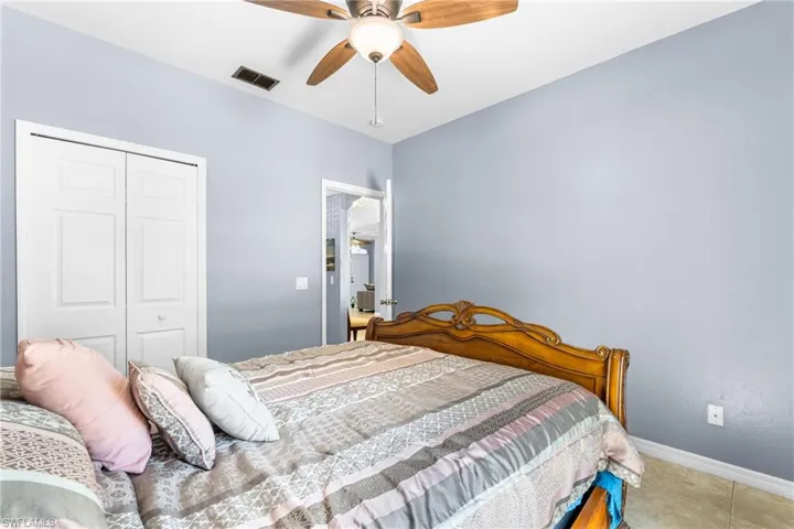 Interior room featuring light blue walls, a white ceiling, and tiled flooring