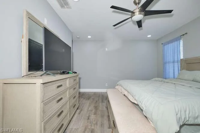 Bedroom featuring light wood-type flooring, ceiling fan, and recessed lighting