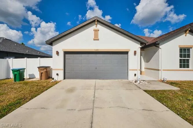 Ranch-style home with stucco siding, concrete driveway, and a garage