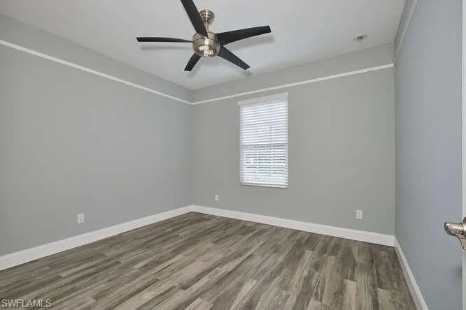 Empty room featuring wood finished floors and ceiling fan