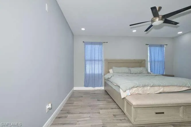 Bedroom featuring light wood-style flooring, a ceiling fan, and recessed lighting