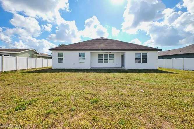 Back of property featuring a patio, a fenced backyard, and stucco siding