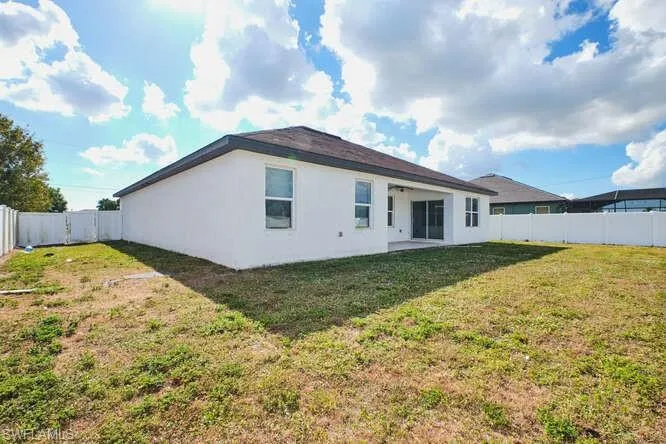 Back of house featuring a fenced backyard, a patio, stucco siding, and a ceiling fan