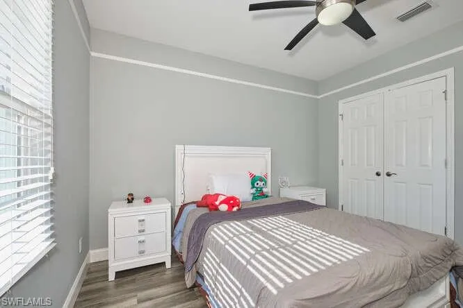Bedroom featuring wood finished floors, ceiling fan, and a closet