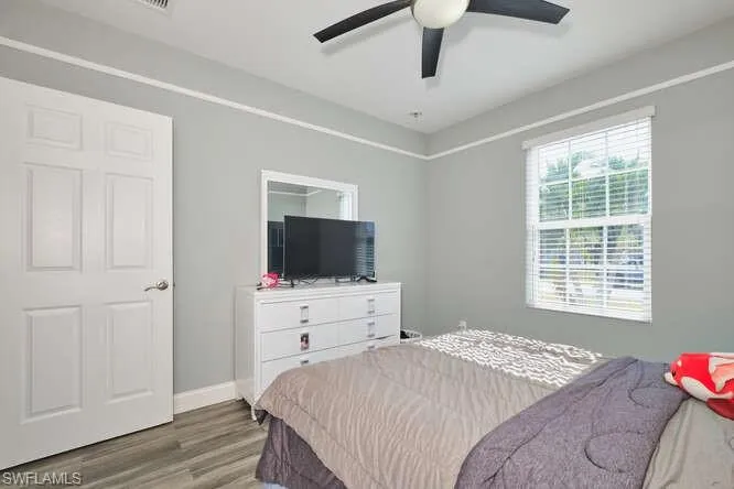 Bedroom with wood finished floors and a ceiling fan