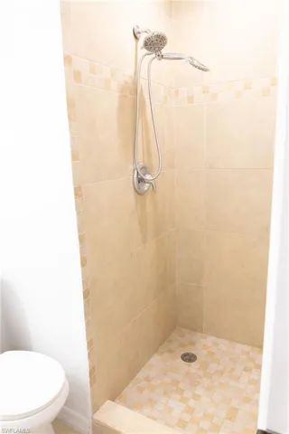 Bathroom featuring a stall shower and toilet