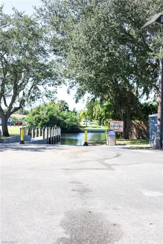 View of asphalt street with a boat ramp and a water view