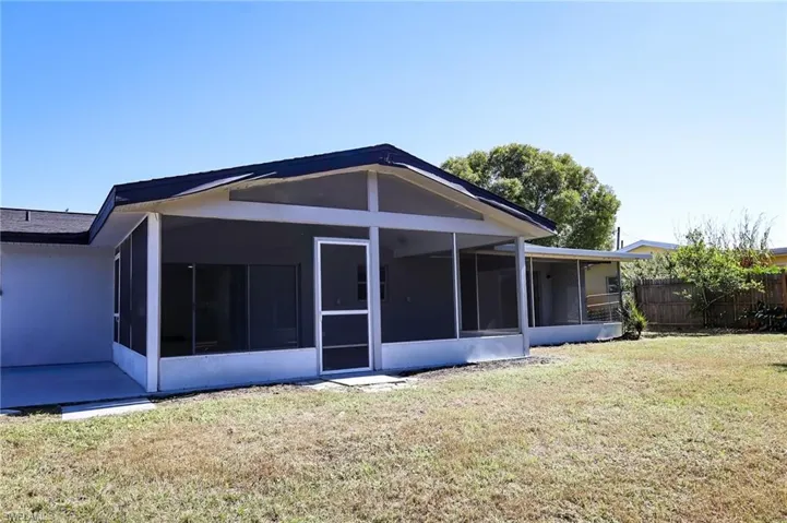 Back of house with a sunroom