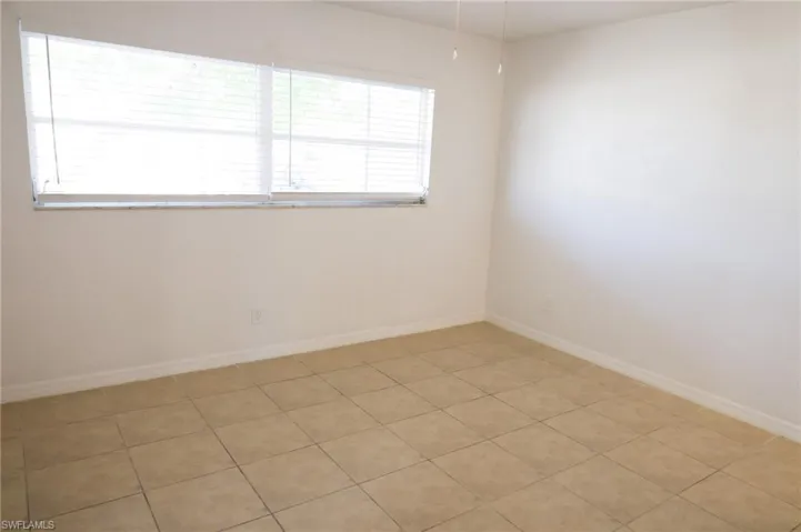 Spare room featuring light tile patterned floors
