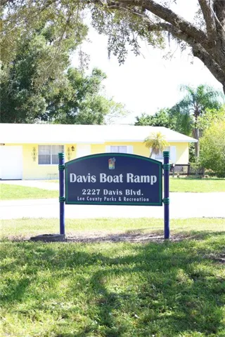 Community / neighborhood sign with a lawn
