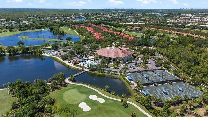 View of property location with a golf club and a large body of water