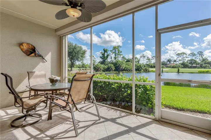 Sunroom / solarium with a water view and ceiling fan