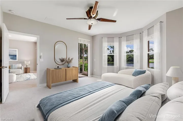 Carpeted bedroom with access to exterior and a ceiling fan