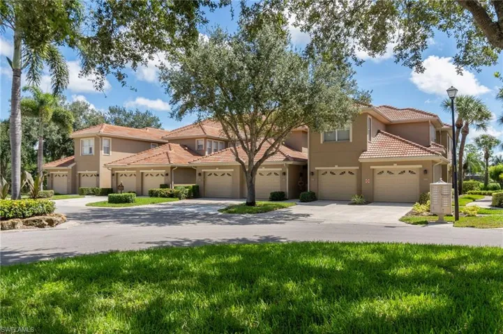 Mediterranean / spanish home with driveway, a tile roof, stucco siding, and a garage