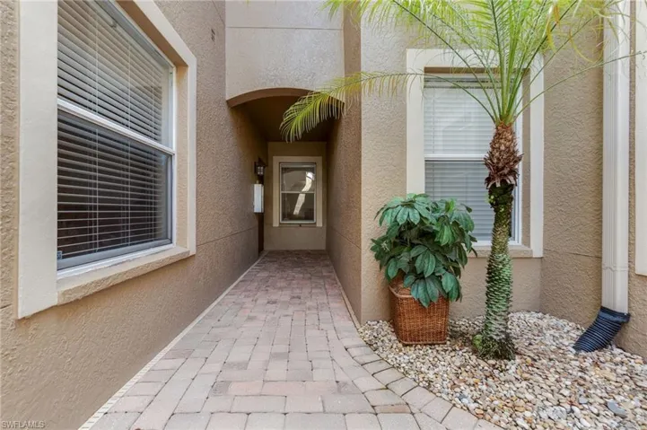 Doorway to property featuring stucco siding