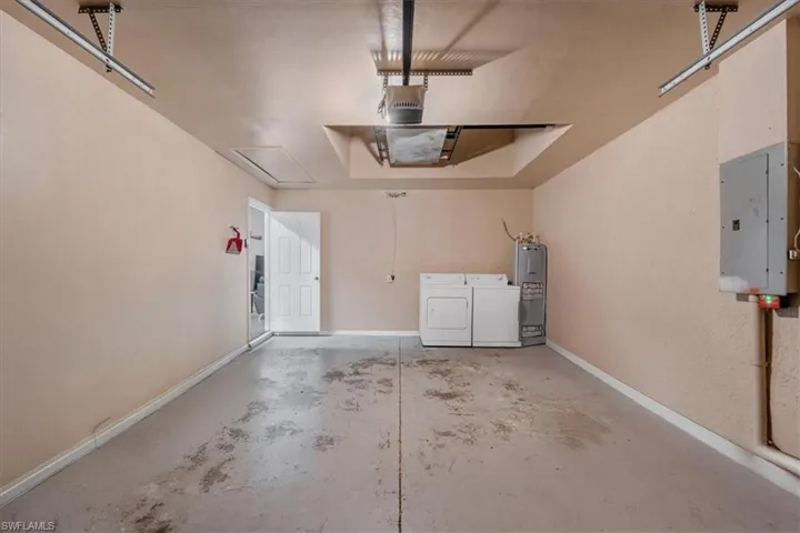 Spacious garage with concrete flooring and light-toned walls