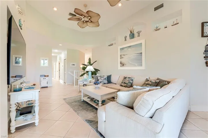 Hallway to the guest bedrooms, guest bath and laundry room at rear, next to stairway