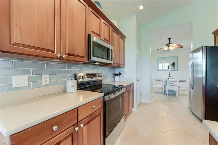 New glass backsplash and formal dining at rear