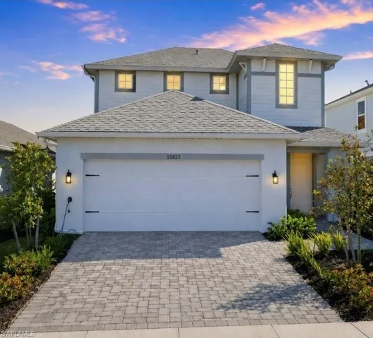 Two-story stucco and siding exterior with a shingled roof