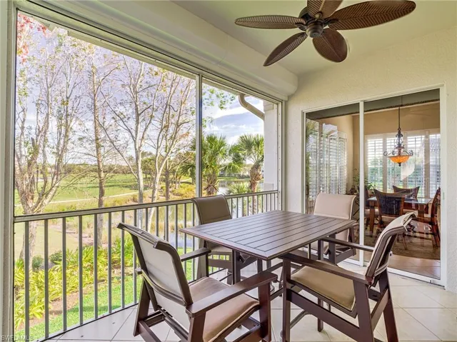 Sunroom / solarium with a wealth of natural light and ceiling fan