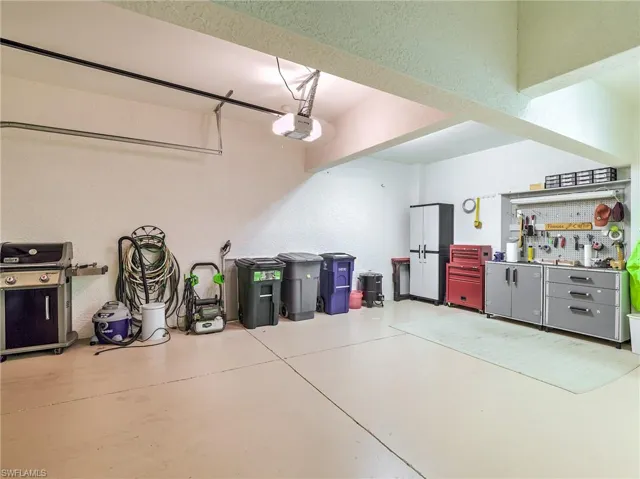 Garage featuring a workshop area and a garage door opener