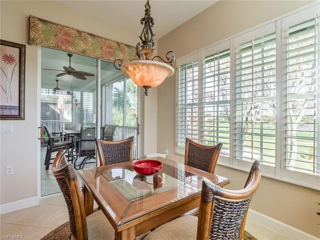 Dining room featuring ceiling fan and light tile floors