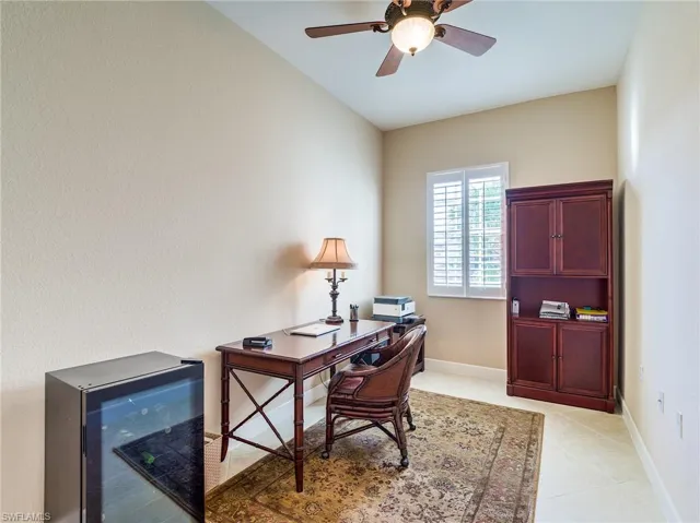 Tiled office featuring ceiling fan