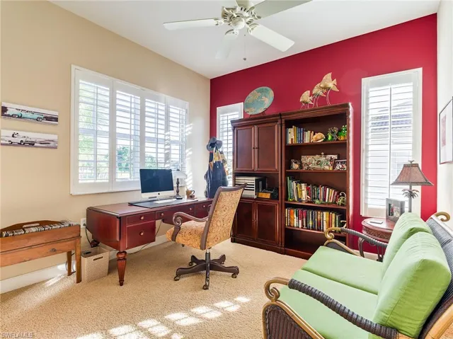 Carpeted home office with ceiling fan