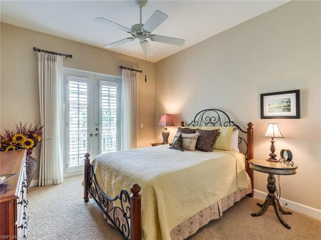 Bedroom featuring carpet flooring, access to exterior, multiple windows, and ceiling fan