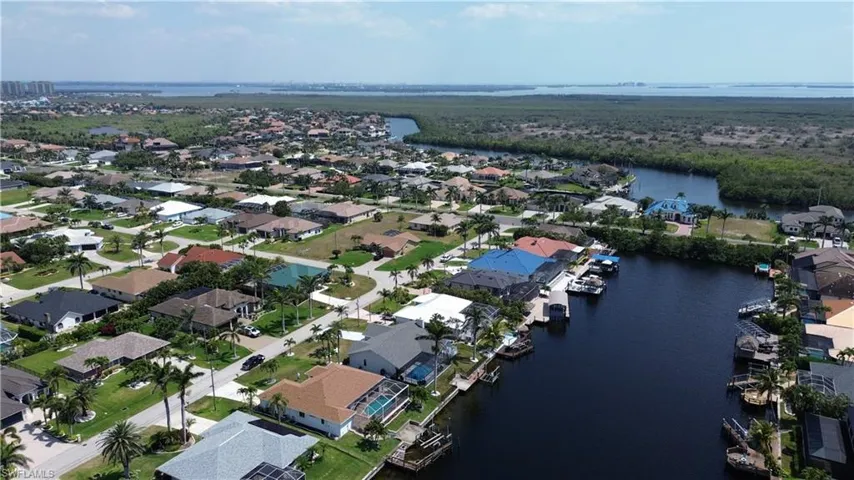 Aerial view featuring a water view and a residential view