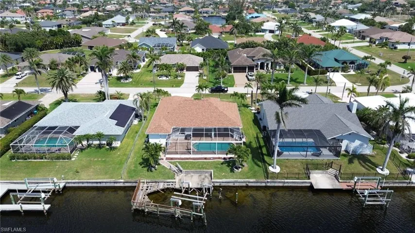 Aerial view featuring a water view and a residential view