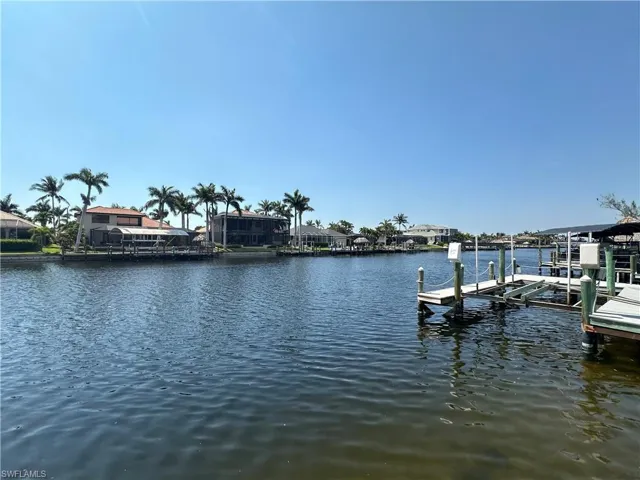 Dock area featuring boat lift and a water view