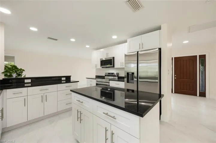 Large sparkling new kitchen overlooking pool and canal