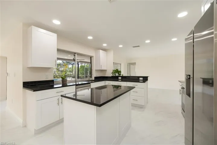 New sun-filled Southern exposure kitchen overlooking pool, spa and lanai with canal beyond