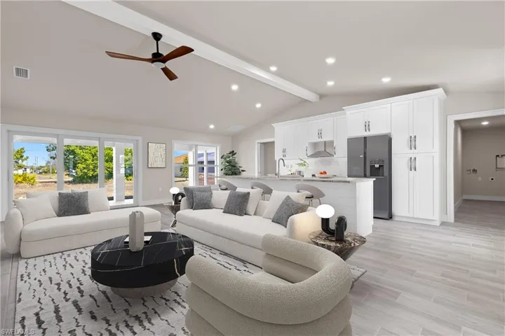 Living area featuring a ceiling fan, light wood-style floors, and recessed lighting
