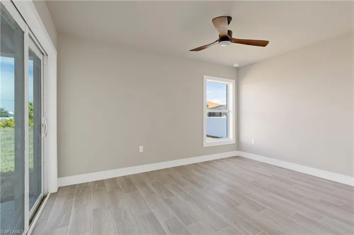 Spare room with wood tiled floors and a ceiling fan
