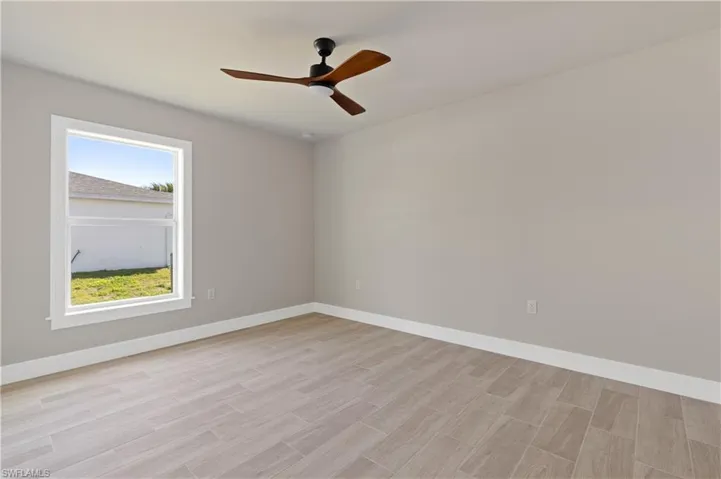 Unfurnished room featuring ceiling fan and wood tiled floors