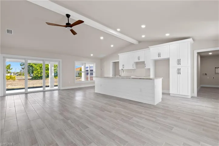 Unfurnished living room featuring wood tiled floors, ceiling fan, and recessed lighting