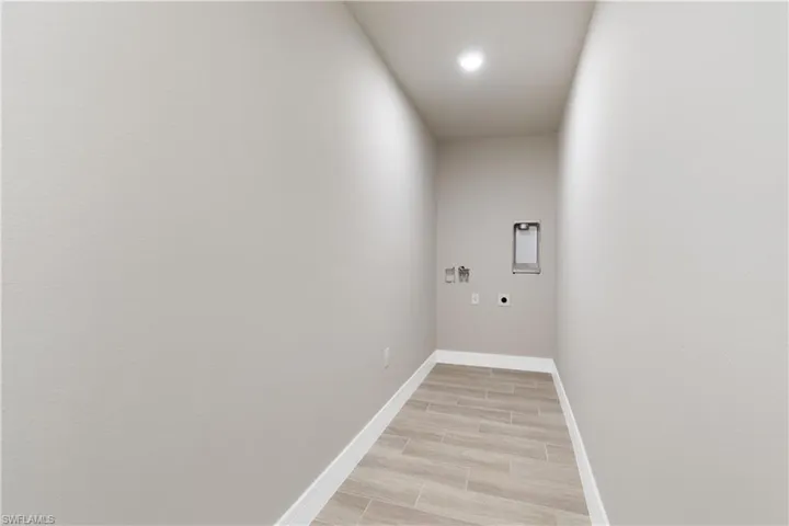 Laundry room with washer hookup, hookup for an electric dryer, wood tiled floors, and recessed lighting