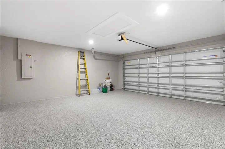 Garage featuring a textured wall and electric panel