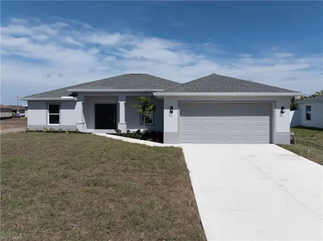 View of front of house featuring a front yard, stucco siding, concrete driveway, a shingled roof, and an attached garage